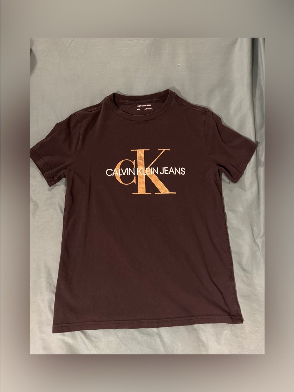 Calvin Klein Jeans men’s  Black Tee with Gold Logo